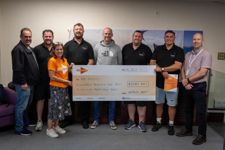 Chris, Leigh and Timmy present the cheque to a delighted Ceri alongside some Impala work colleagues and Steve Roberts